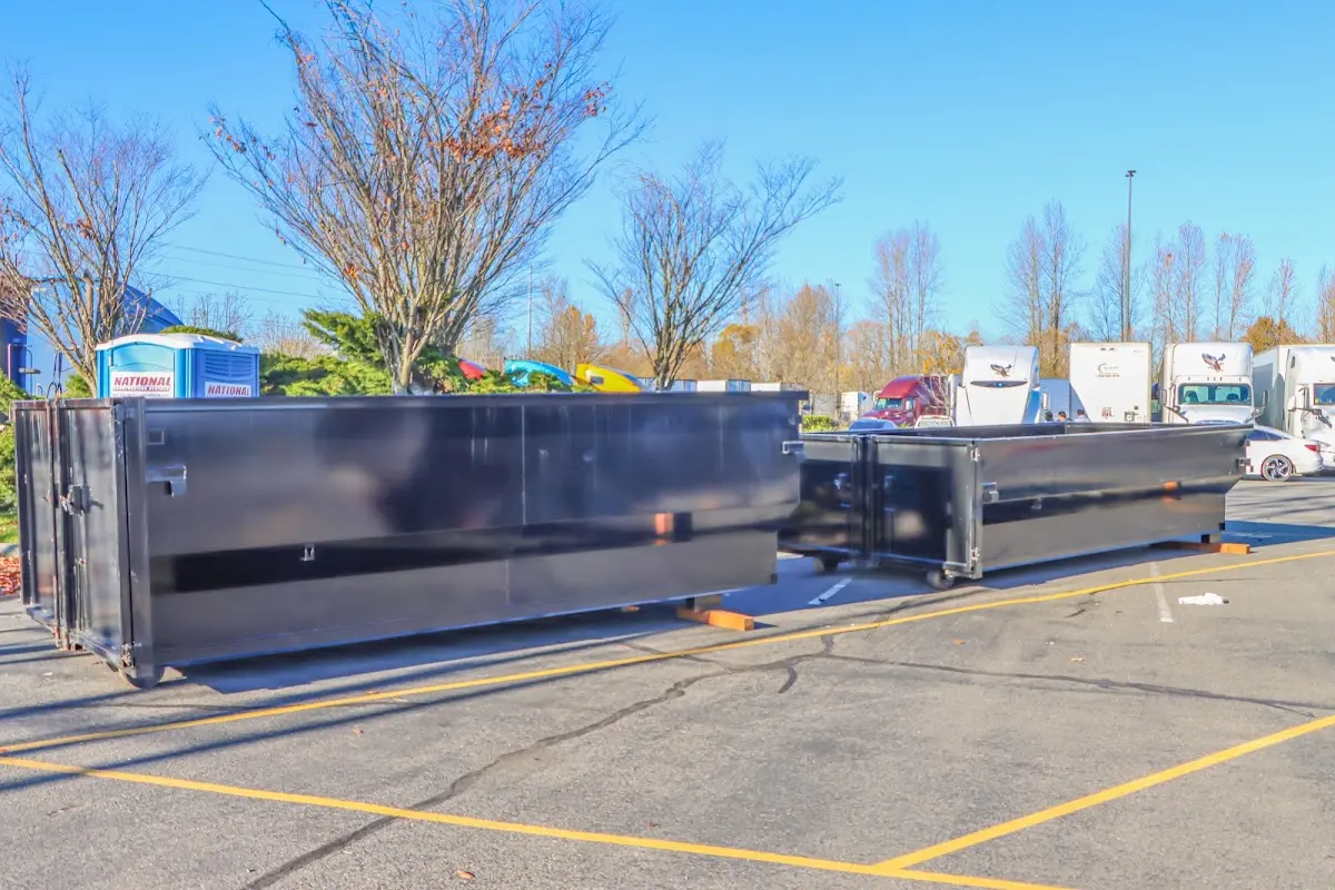 Professional dumpster rental service with roll-off container on residential driveway in Big Stone Gap